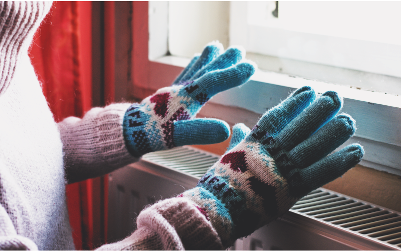 Person warming up with gloves on indoors