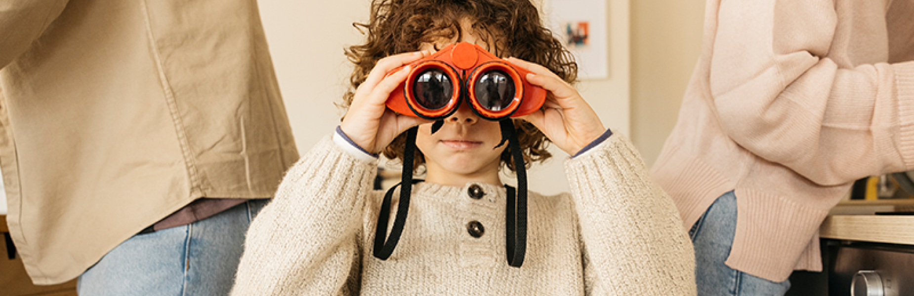 picture of a child looking  through a pair of binoculars