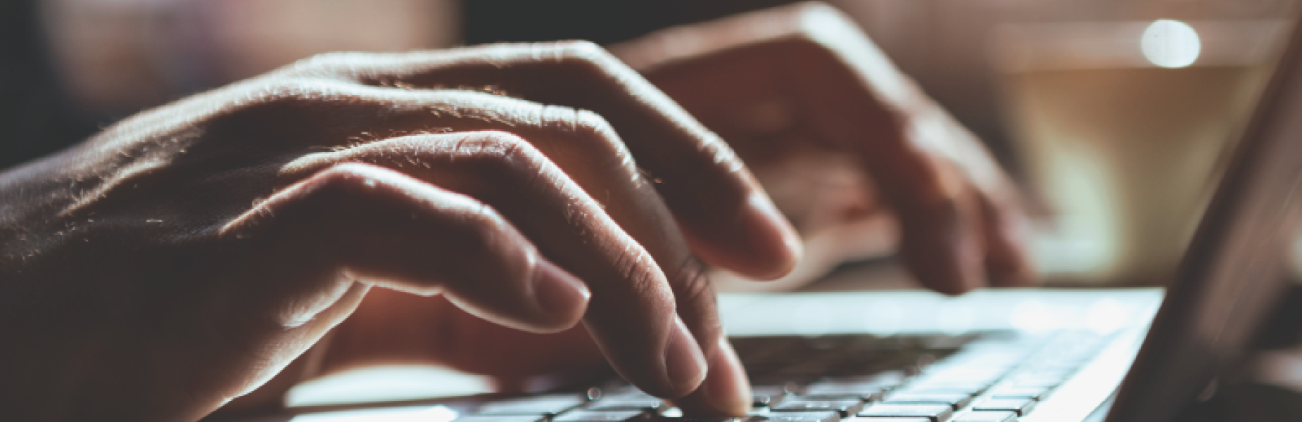 Hands at a laptop keyboard