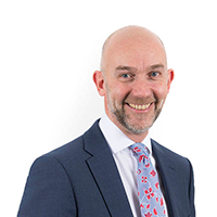 Headshot photograph of Adrian Crompton
